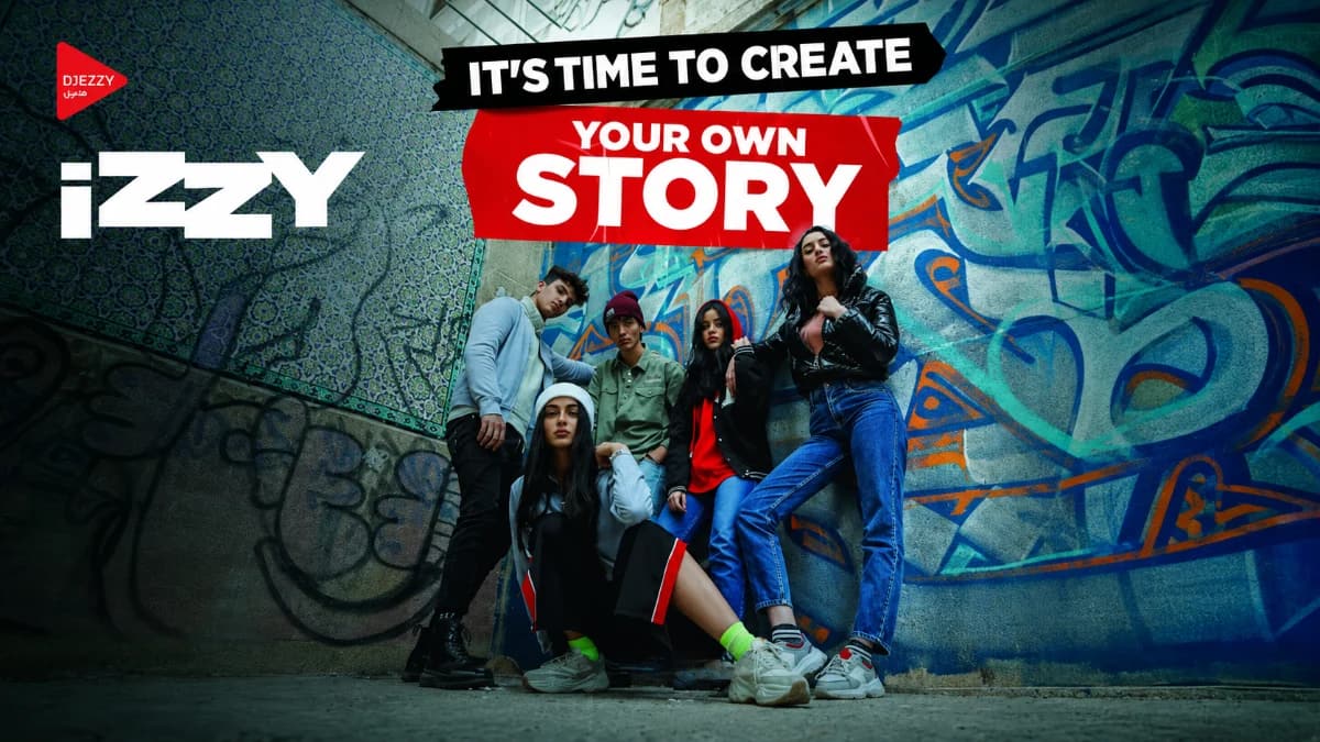 Izzy by Djezzy launch campaign — "It's time to create your own story" key visual, shot with young Algerian creators in an urban setting.